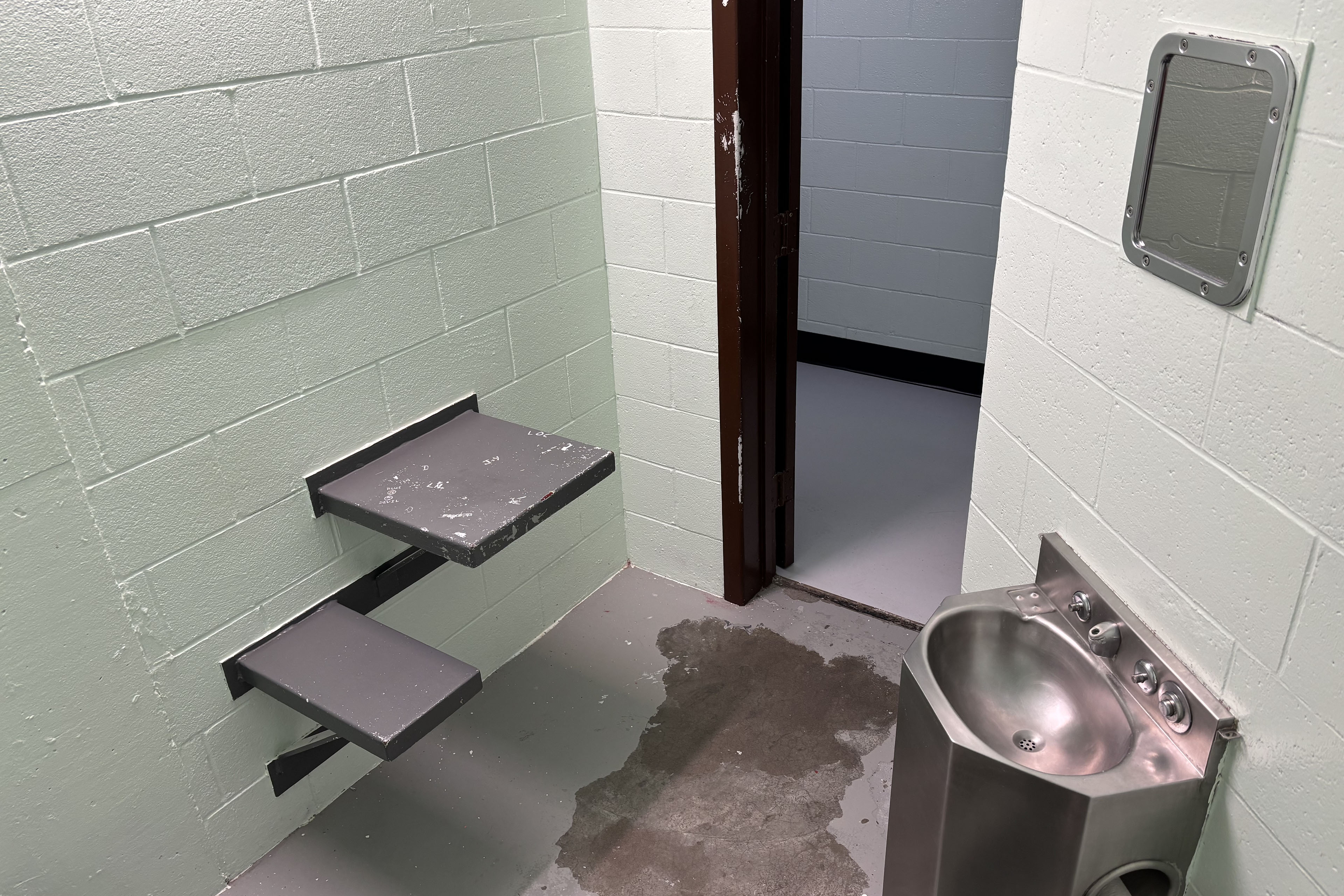 An interior of a small prison cell.