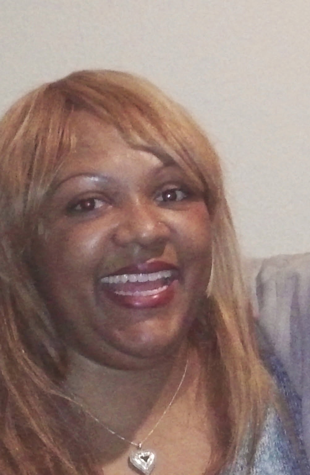 A photo of a Black woman smiling.